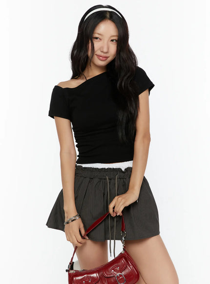 LEWKIN One-Shoulder Shirred Short Sleeve Top CU529 Black S/M front view on model wearing headband with asymmetric neckline and ruched fabric