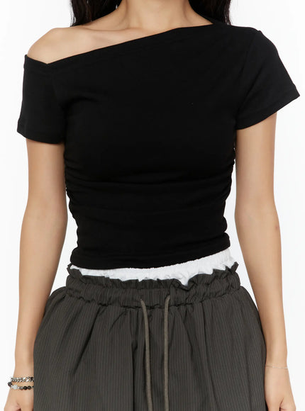 One-Shoulder Shirred Short Sleeve Top CU529 Black close-up front on model showing asymmetric one-shoulder neckline ruched fabric and lace trim hem detail