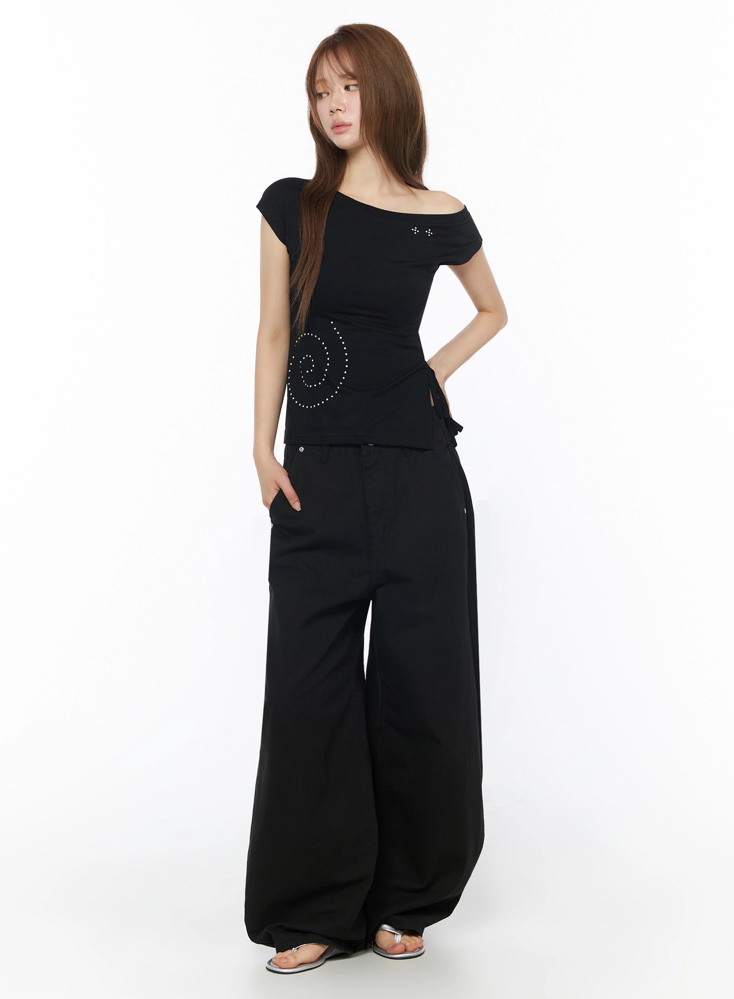 One-Shoulder Spiral Top IL502 Black front shot on model in full-length view with wide-leg pants, asymmetric neckline and spiral rhinestone stud motif at waist