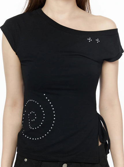 One-Shoulder Spiral Top IL502 Black close-up front shot on model showing asymmetric one-shoulder neckline with star rhinestone studs and spiral stud motif at hem