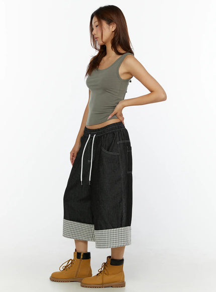 Open-Back Tank Top CL515 dark green side shot on model with hand on hip, showing fitted crop length and side tie detail, styled with black denim culottes