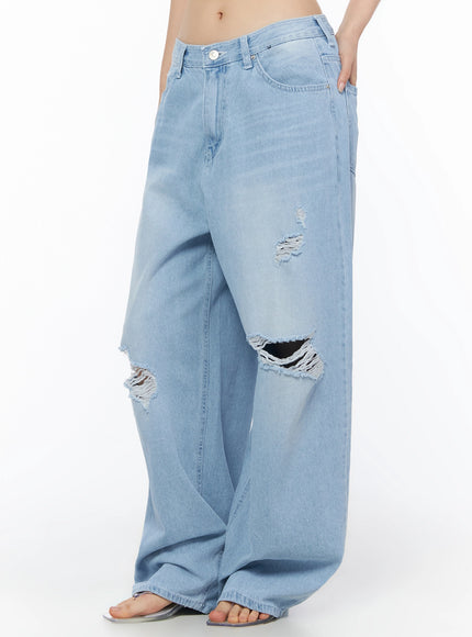 Ophelia Distressed Baggy Jeans IL502 Light blue side crop shot on model from waist down showing ripped knee detail, button fly, and oversized wide-leg denim silhouette
