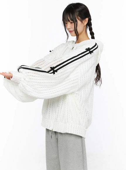 Oversized Bow Detail Windbreaker CU530 White back view on model lifting hood showing ribbed semi-sheer knit black stripe sleeves boxy oversized silhouette