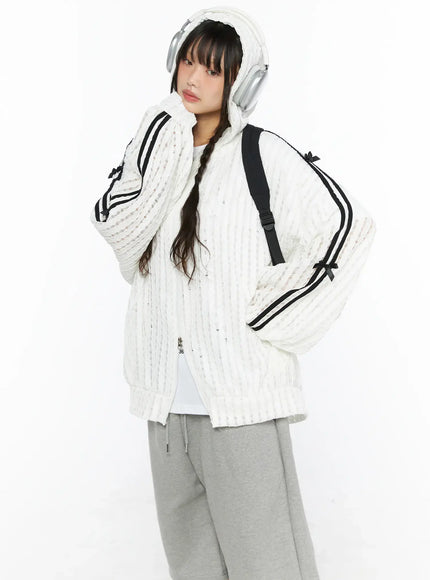 LEWKIN Oversized Bow Detail Windbreaker CU530 White M/L three-quarter front view on model wearing hood with headphones black backpack gray shorts sneakers