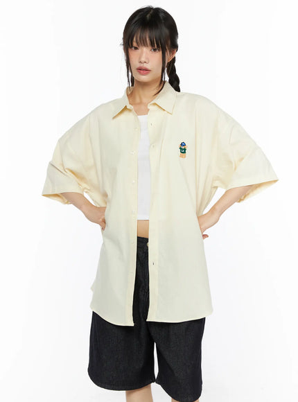 Oversized Button-Up Shirt CU530 Light yellow front cropped shot on model arms at sides showing LA bear embroidery button placket and drop-shoulder sleeve
