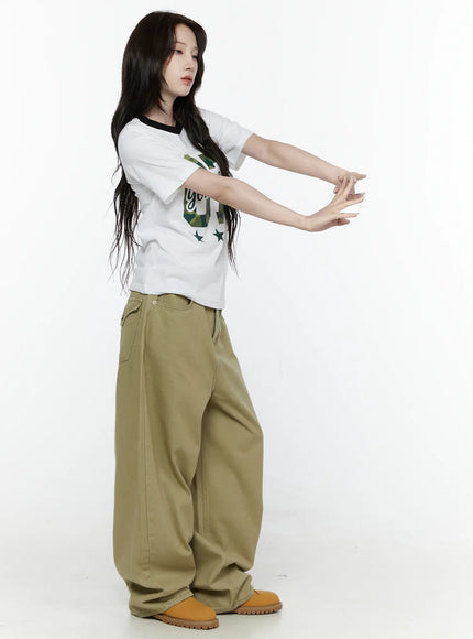 Oversized Cargo Pants IL522 Beige side styled shot on model arms outstretched showing exaggerated wide-leg silhouette and twill fabric drape