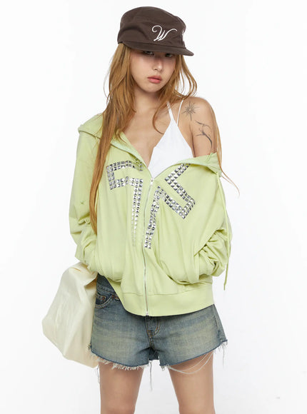LEWKIN Oversized Cross Graphic Zip-Up Hoodie CL528 Light green S/M front model half-bust shot zip open off-shoulder pose silver pyramid stud cross detail