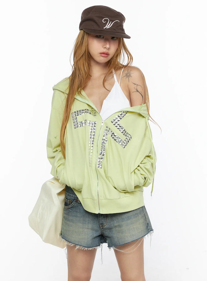 LEWKIN Oversized Cross Graphic Zip-Up Hoodie CL528 Light green S/M front model half-bust shot zip open off-shoulder pose silver pyramid stud cross detail
