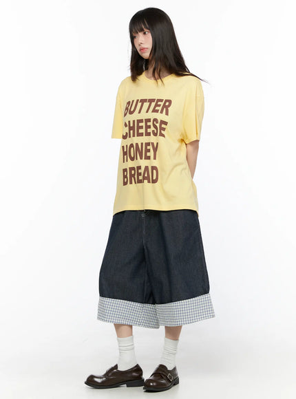 Oversized Graphic Tee CL522 Yellow full-length front view on model styled with layered denim culottes socks and brown loafers