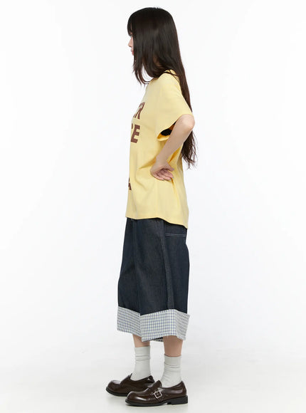 Oversized Graphic Tee CL522 Yellow side view on model hand on hip showing relaxed boxy silhouette and short sleeve length