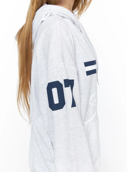 Oversized Graphic Zip-Up Hoodie CL528 Light Gray side close-up detail shot on model showing navy 07 number print on sleeve and stripe graphic on chest fleece texture
