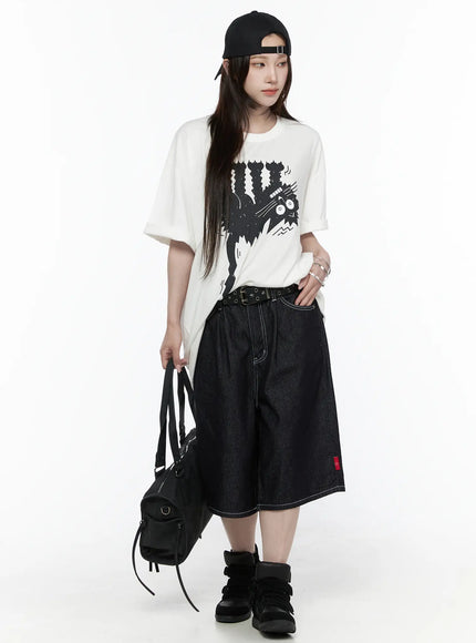 Oversized Kitty Graphic T-Shirt IL516 White full-body front shot female model with cap holding black bag showing complete styled outfit with dark denim shorts and black sneakers