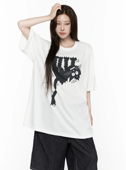 Oversized Kitty Graphic T-Shirt IL516 White front shot female model hand raised to head wearing oversized graphic tee with round neck and dropped shoulders