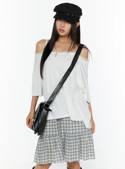 LEWKIN Oversized Lace-Detail Off-Shoulder Tee CU529 White M/L front shot on model wearing baker boy cap and black crossbody bag styled with plaid skirt