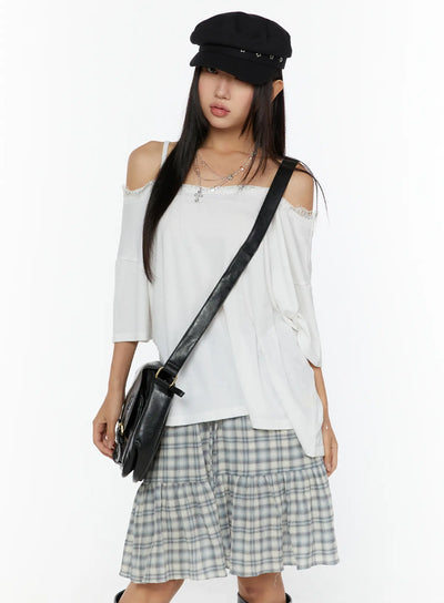 LEWKIN Oversized Lace-Detail Off-Shoulder Tee CU529 White M/L front shot on model wearing baker boy cap and black crossbody bag styled with plaid skirt