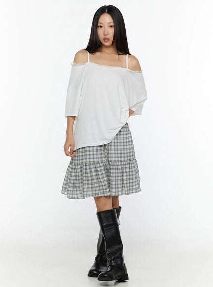 Oversized Lace-Detail Off-Shoulder Tee CU529 White full-body front shot on model showing relaxed fit lace neckline trim with plaid skirt and knee-high boots