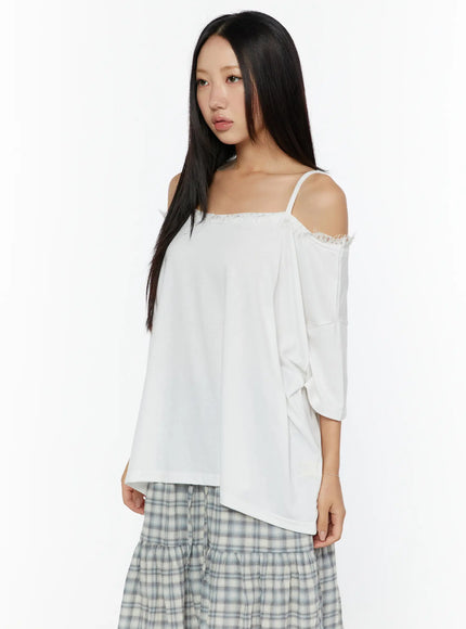 Oversized Lace-Detail Off-Shoulder Tee CU529 White angled front close-up shot on model highlighting fringe lace neckline trim and cold-shoulder strap detail