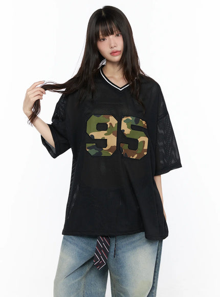 Oversized Mesh Jersey CL523 Black front model shot with camouflage 95 applique patch, mesh texture, V-neck with white stripe trim, styled with jeans