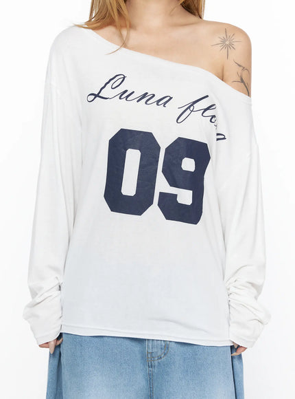 Oversized Off-Shoulder Graphic Long Sleeve Top CL528 White close-up front model torso shot showing Luna Flora navy script and large 09 number print on soft fabric
