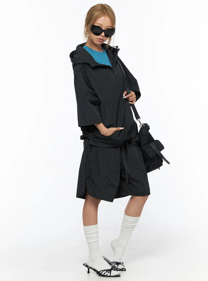 Oversized Plaid Windbreaker CU523 Black styled full-length shot model wearing jacket open with black crossbody bag sunglasses teal top and matching shorts with heeled sandals