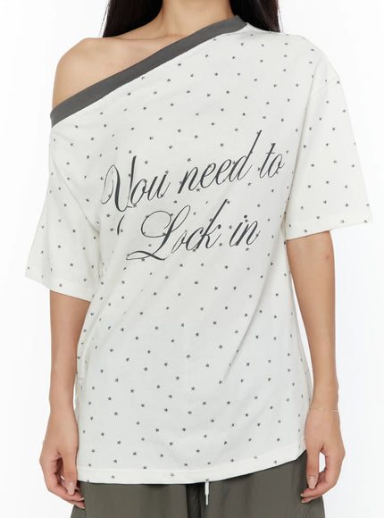 Oversized Polka Dot Off-Sholder Tee CU526 White close-up front detail shot showing script You need to Lock in graphic print star pattern and gray off-shoulder trim