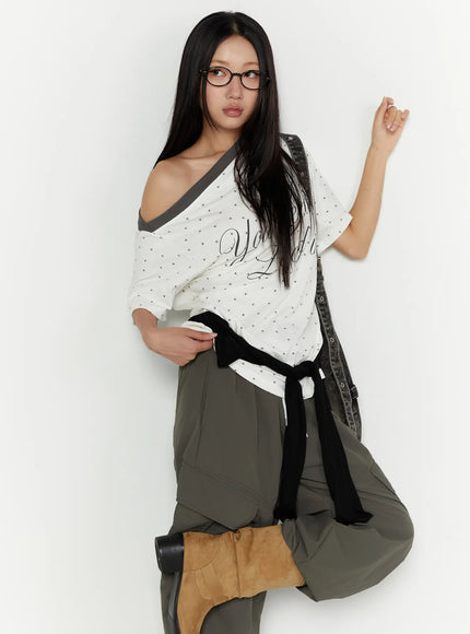 LEWKIN Oversized Polka Dot Off-Sholder Tee CU526 White M/L three-quarter shot model wearing off-shoulder style with star print and gray diagonal neckline trim styled with bag
