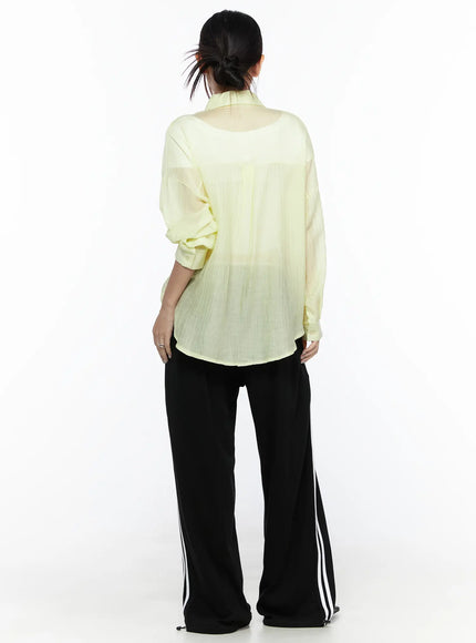 Oversized Sheer Shirt CL524 Yellow back model shot displaying sheer crinkle texture, dropped shoulders, curved hem, paired with stripe trousers