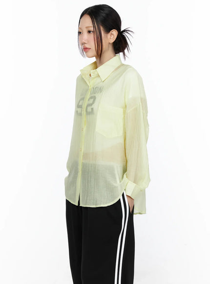 Oversized Sheer Shirt CL524 Yellow side-front close-up model shot highlighting chest pocket, sheer layering over graphic tee, button placket detail