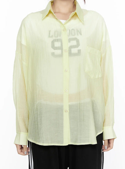 Oversized Sheer Shirt CL524 Yellow close-up torso front shot showing point collar, semi-sheer crinkle fabric, button front, chest pocket, inner graphic tee visible
