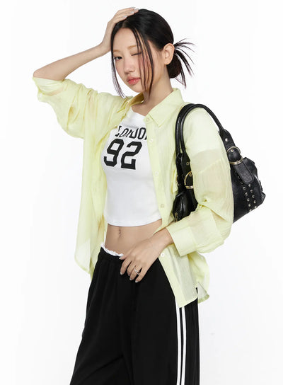 LEWKIN Oversized Sheer Shirt CL524 Yellow S/M styled open over white graphic crop top, three-quarter angle model shot with black bag