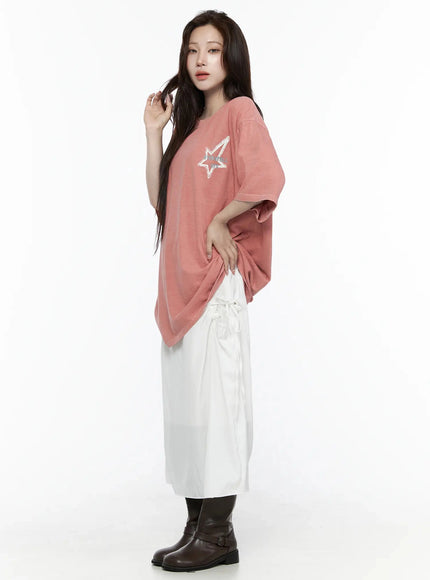 Oversized Star Graphic T-Shirt IL516 Pink side view on female model hand in hair styled with white drawstring skirt and dark leather boots