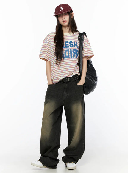 Oversized Striped Graphic Tee CL523 light beige full-length front model styled with burgundy cap and black bag hands in pockets street style look