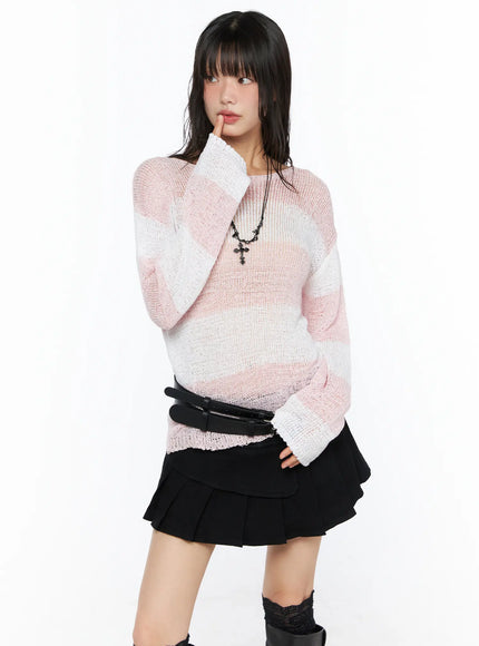 LEWKIN Oversized Striped Knit Sweater CU530 Pink S/M front shot on model posing with hand near face wearing sheer open-knit top with black mini skirt and boots