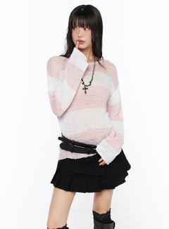 LEWKIN Oversized Striped Knit Sweater CU530 Pink S/M front shot on model posing with hand near face wearing sheer open-knit top with black mini skirt and boots