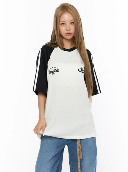 Oversized Waffle Knit Tee CU523 black colorway front model close-up shot, ivory waffle knit body with black raglan sleeves and Ghost Club 1987 chest embroidery