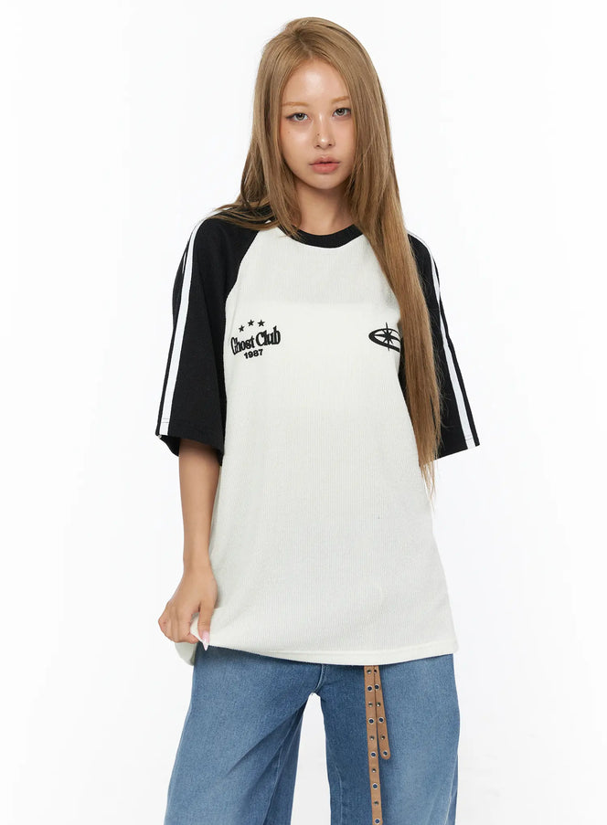 Oversized Waffle Knit Tee CU523 black colorway front model close-up shot, ivory waffle knit body with black raglan sleeves and Ghost Club 1987 chest embroidery