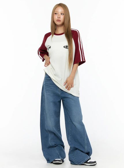 Oversized Waffle Knit Tee CU523 Dark red full-length front model shot, ivory waffle knit body with dark red raglan sleeves paired with wide-leg blue jeans