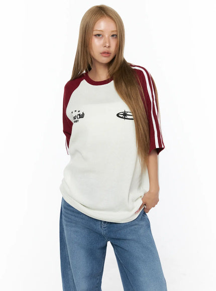 Oversized Waffle Knit Tee CU523 Dark red front model portrait shot, ivory ribbed waffle knit body with dark red raglan sleeves, white stripe detail and chest embroidery