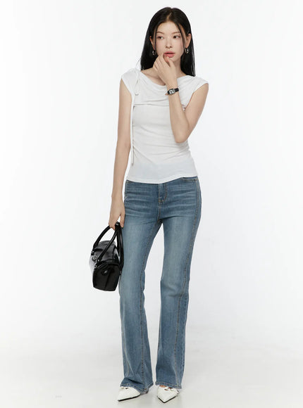Paget Flared Bootcut Jeans IL506 Blue full-length front view on model holding black bag hand near face styled with white top and white heels