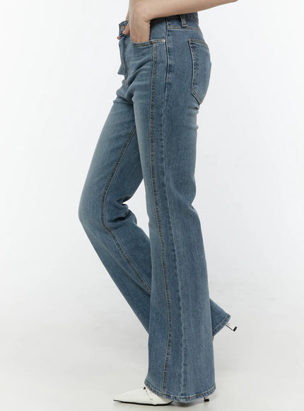 Paget Flared Bootcut Jeans IL506 Blue side view on model cropped at waist hand in pocket showing center seam detail and flare from knee