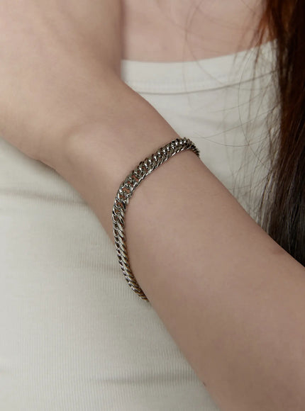 Parker 8mm Chain Bracelet IL522 silver on model wrist resting against white top showing full bracelet fit and chunky curb chain width