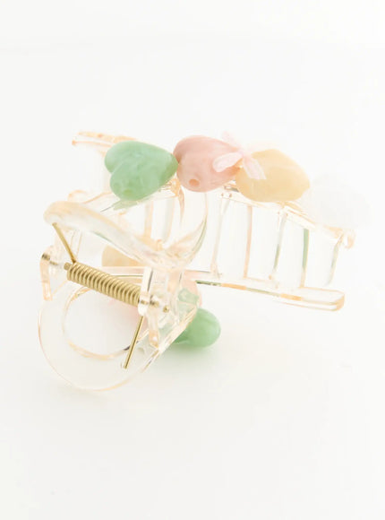 Pearl Green Hair Clip IL503 clear transparent claw clip detail close-up showing gold coil spring hinge mechanism and pastel heart stone charms on top