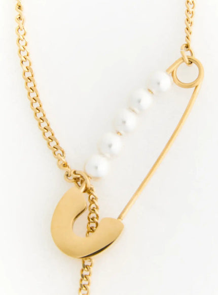 Pearl Safety Pin Necklace IL522 Gold close-up detail of safety pin clasp with row of white pearls and gold curb chain on white background