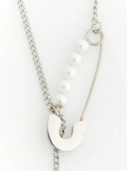 Pearl Safety Pin Necklace IL522 Silver close-up detail of safety pin pendant with six white pearls and silver curb chain on white background