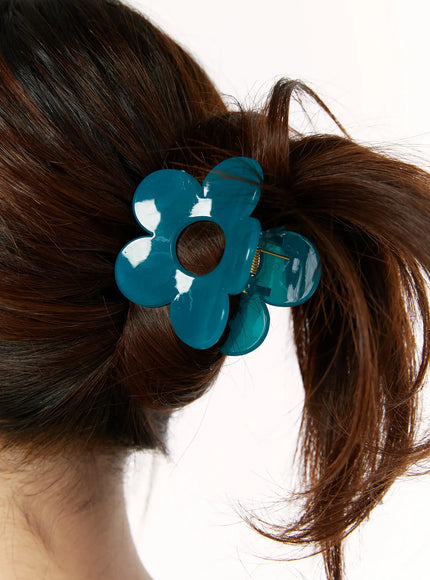 Petal Hair Pin IL514 Teal close-up on model worn in half-up bun hairstyle showing glossy flower shape securing dark brown hair