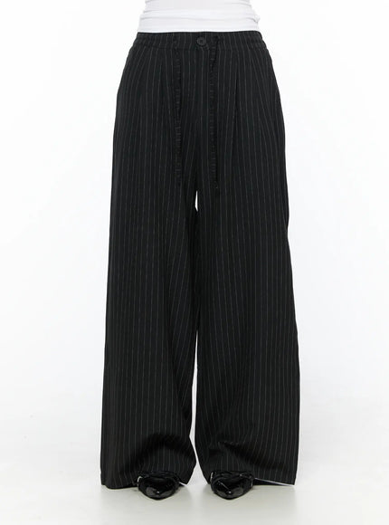 Pinstripe Wide Leg Trousers CL513 Black front shot on model showing button waistband pleated center seam and full wide-leg silhouette with patent loafers