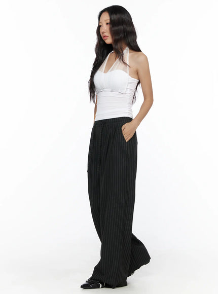 Pinstripe Wide Leg Trousers CL513 Black side-angle full-length shot on model in white halter top hand in pocket showing relaxed wide-leg silhouette
