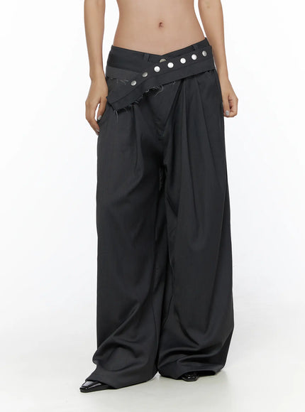 Pintuck Belted Wide Slacks CL510 dark gray front close-up on model, crossover V-waistband with silver studs, raw-edge frayed hem detail, deep pleats