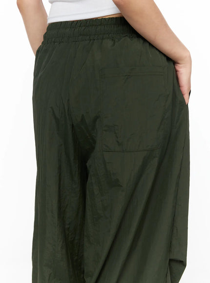 Pintuck Nylon Wide Pants CL514 Dark green close-up back detail showing elastic waistband ruching and large patch back pocket in crinkled nylon