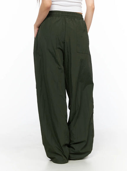 Pintuck Nylon Wide Pants CL514 Dark green back view on model standing showing elastic waistband back pocket and oversized wide-leg nylon drape